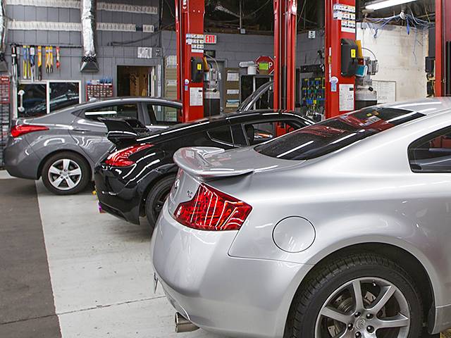 Mitsubishi auto repair shop with cars on racks